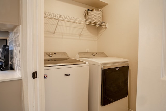 clothes washing area featuring laundry area and washing machine and clothes dryer