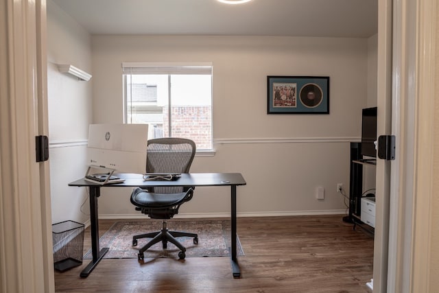 office space with baseboards and wood finished floors