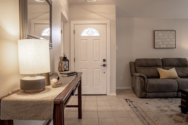 entrance foyer with light tile patterned flooring and baseboards