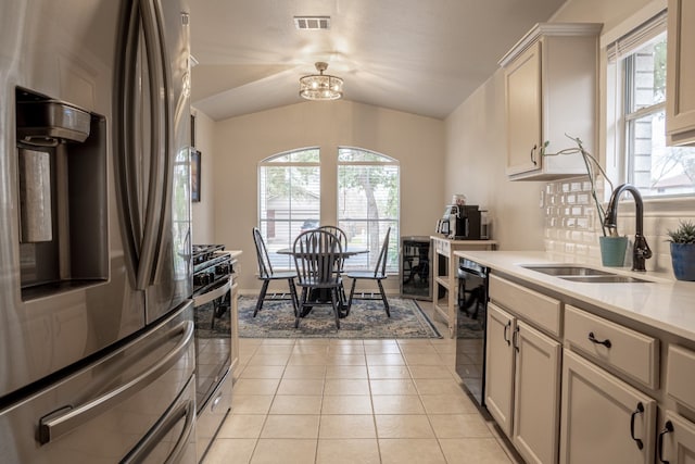 kitchen with light tile patterned floors, visible vents, appliances with stainless steel finishes, light countertops, and a sink