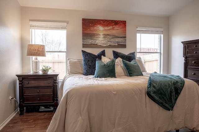 bedroom with wood finished floors and baseboards