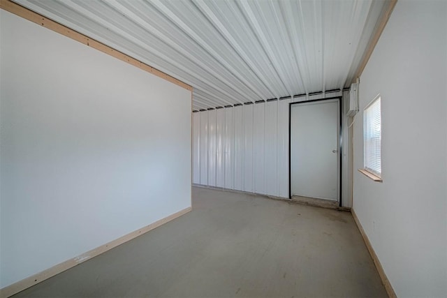 unfurnished room with baseboards