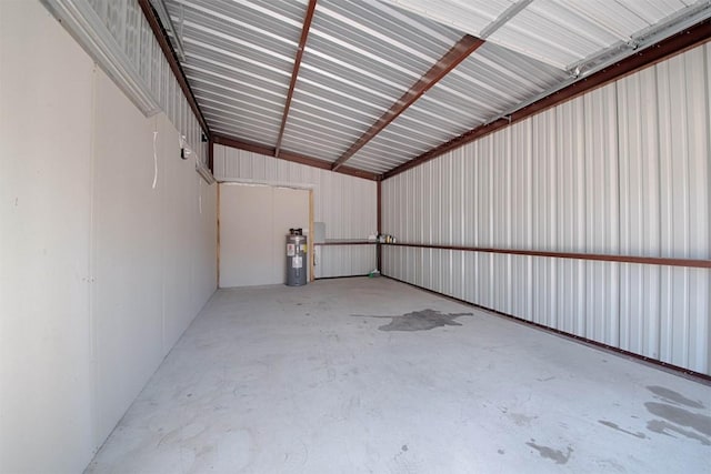 garage with water heater and metal wall