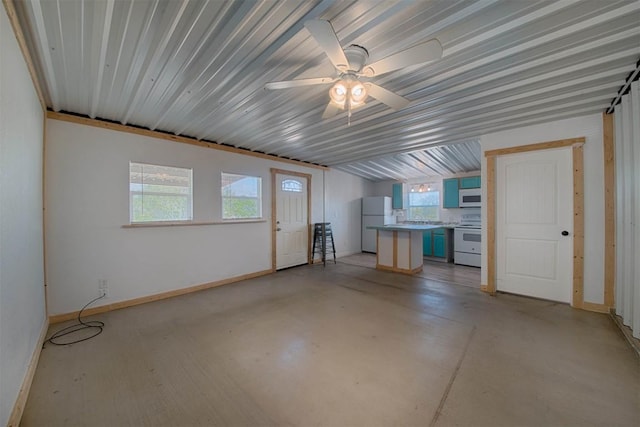 interior space featuring concrete flooring, baseboards, and a ceiling fan