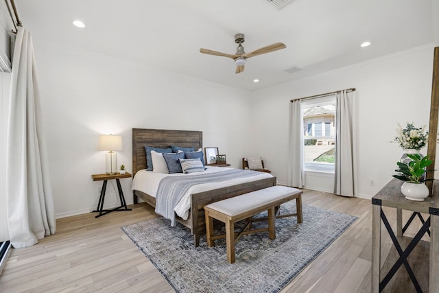 bedroom with light wood-type flooring, baseboards, crown molding, and recessed lighting