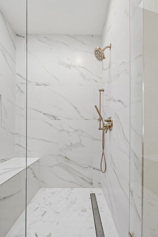 bathroom with a marble finish shower