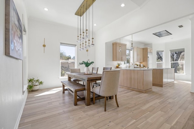 dining space with light wood-style flooring, visible vents, crown molding, and recessed lighting