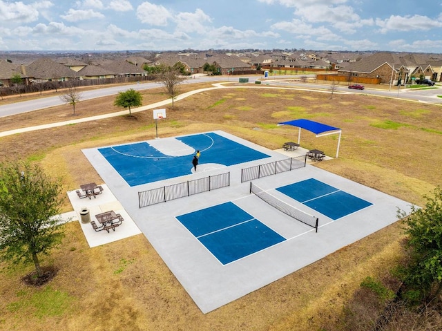 view of swimming pool with community basketball court, a residential view, fence, and a lawn