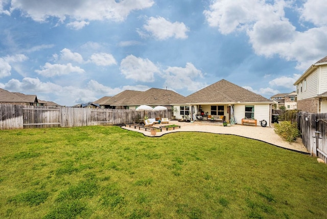 back of property with a patio area, a fenced backyard, and a lawn