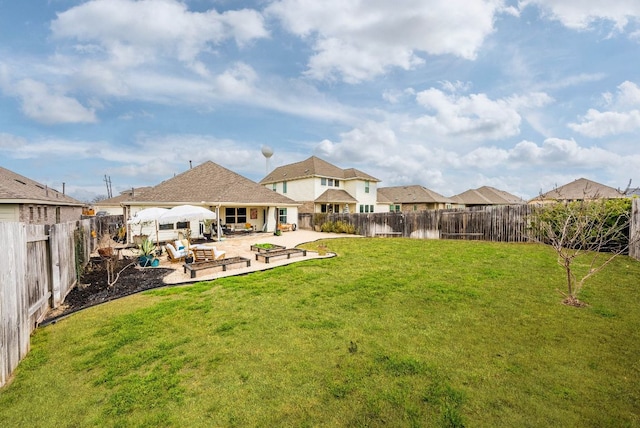 rear view of property featuring a patio area, a lawn, and a fenced backyard