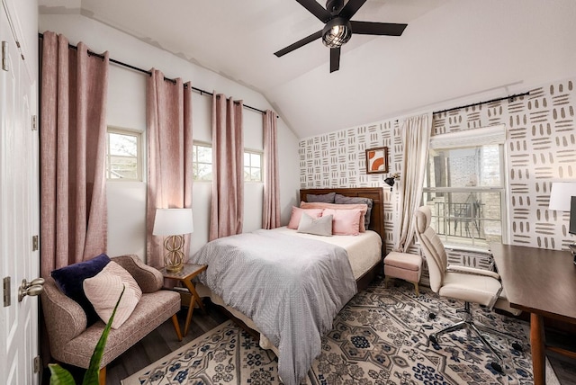 bedroom featuring vaulted ceiling, ceiling fan, wood finished floors, and wallpapered walls