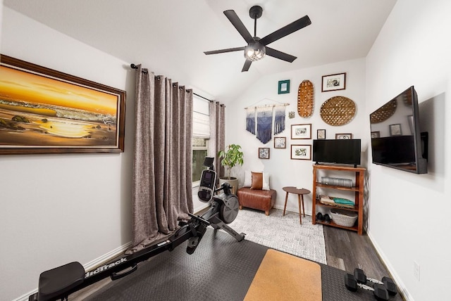 workout room with lofted ceiling, ceiling fan, wood finished floors, and baseboards