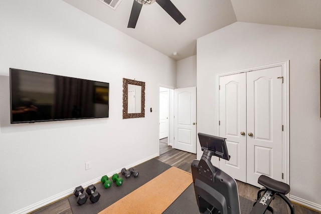 exercise room featuring lofted ceiling, a ceiling fan, baseboards, and wood finished floors