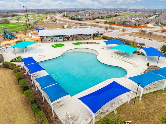 community pool featuring fence and a patio