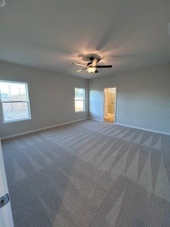 unfurnished bedroom featuring carpet flooring, a ceiling fan, and baseboards