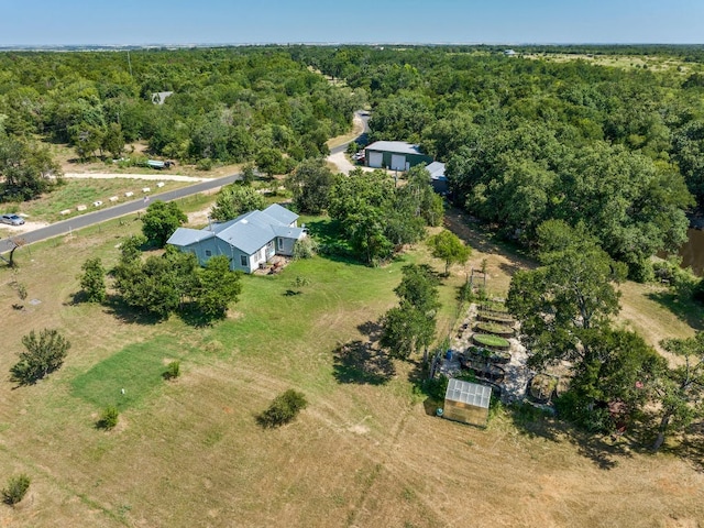 birds eye view of property featuring a wooded view