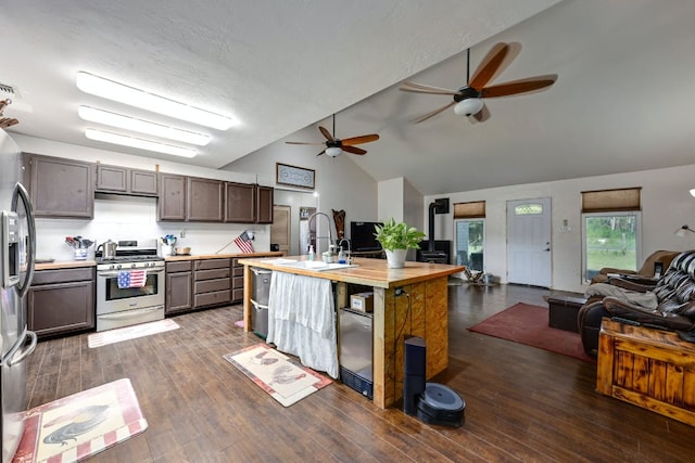 kitchen featuring dark wood-type flooring, appliances with stainless steel finishes, open floor plan, and a sink