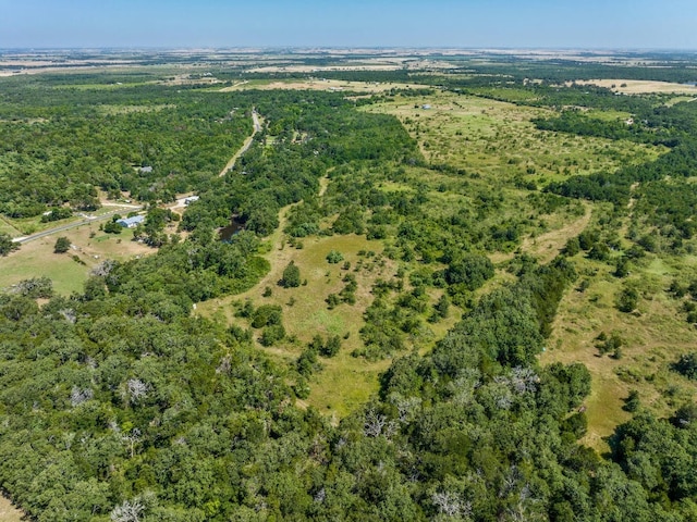 birds eye view of property with a view of trees