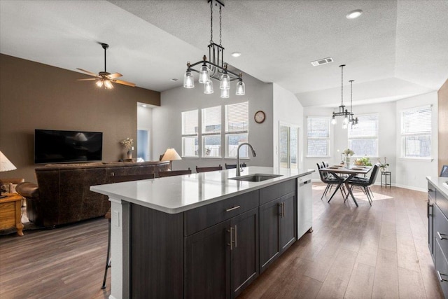 kitchen with visible vents, dishwasher, dark wood-style floors, light countertops, and a sink