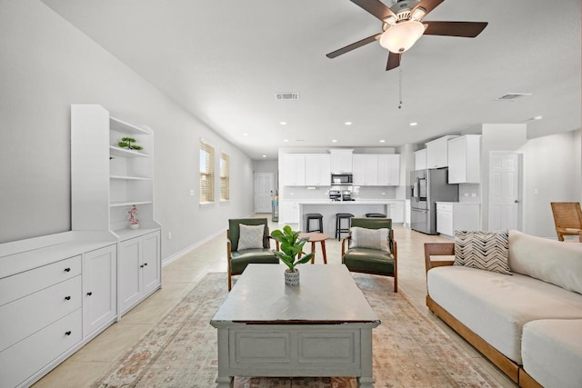 living area featuring a ceiling fan, recessed lighting, visible vents, and light tile patterned floors