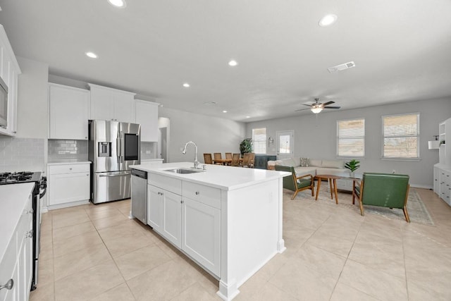 kitchen with stainless steel appliances, plenty of natural light, visible vents, and a sink