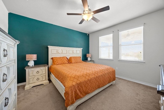 bedroom with light carpet, a ceiling fan, and baseboards