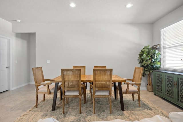 dining room with light tile patterned floors, baseboards, and recessed lighting