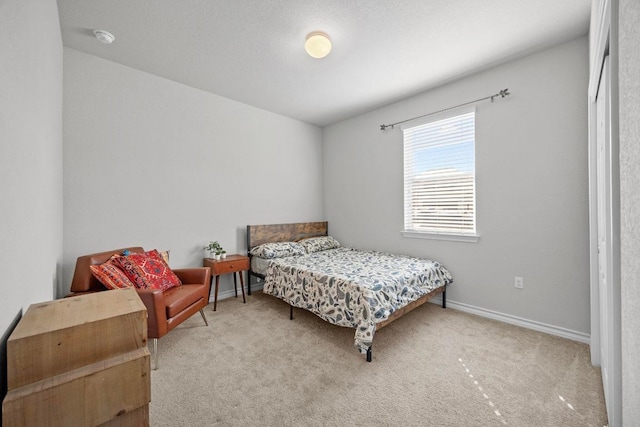 carpeted bedroom featuring baseboards