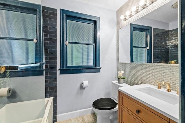 full bath with decorative backsplash, toilet, vanity, wood finished floors, and baseboards