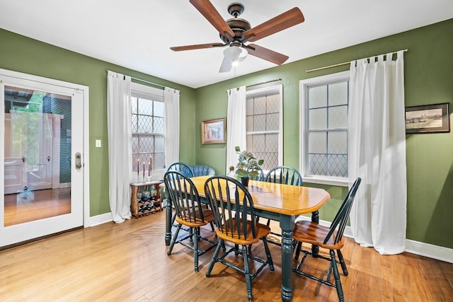 dining room with ceiling fan, light wood-style flooring, and baseboards