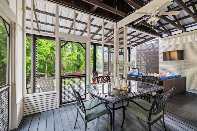 sunroom with lofted ceiling and a ceiling fan