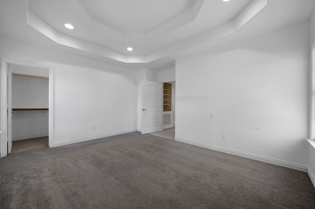 106 Park Dr, Bastrop, TX 78602 - unfurnished bedroom with a raised ceiling, carpet, recessed lighting, and a walk in closet