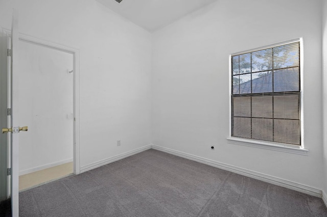 carpeted empty room with baseboards