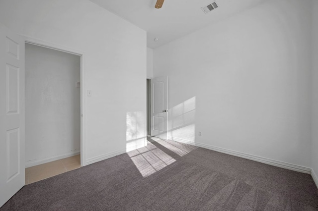 unfurnished bedroom with carpet, visible vents, and baseboards