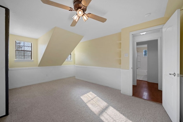 additional living space featuring lofted ceiling, baseboards, and carpet flooring