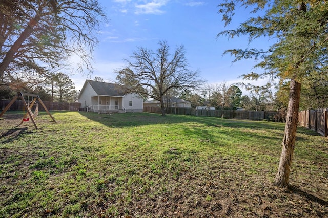 view of yard featuring a playground and a fenced backyard