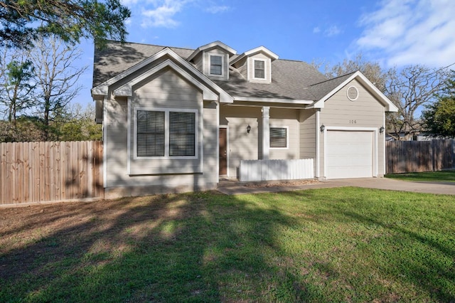 view of front of house featuring a garage, fence, a front lawn, and concrete driveway