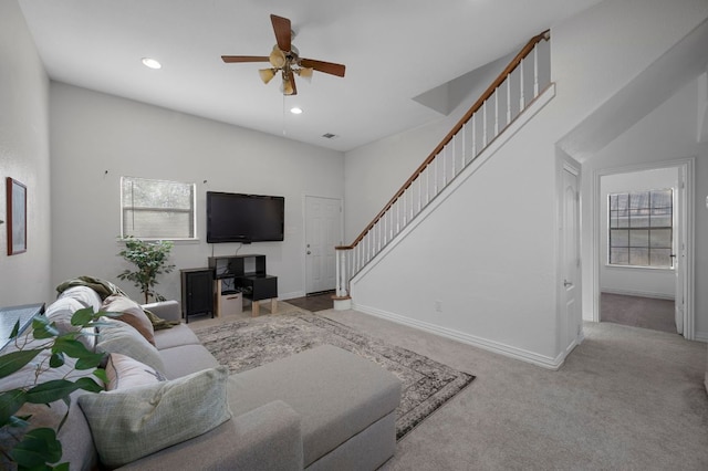 living room with baseboards, stairway, carpet flooring, and a healthy amount of sunlight