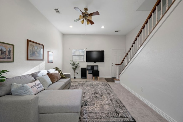 living room with baseboards, stairs, visible vents, and carpet flooring