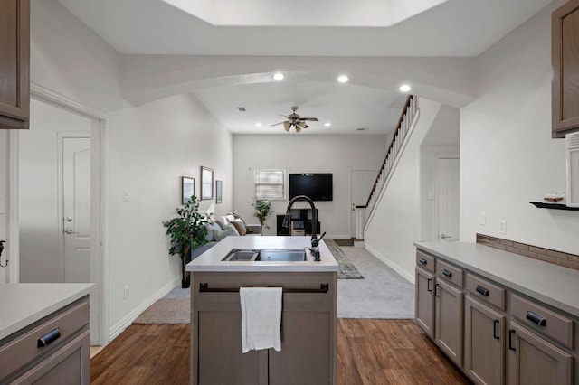 kitchen featuring recessed lighting, a ceiling fan, open floor plan, a kitchen island with sink, and a sink