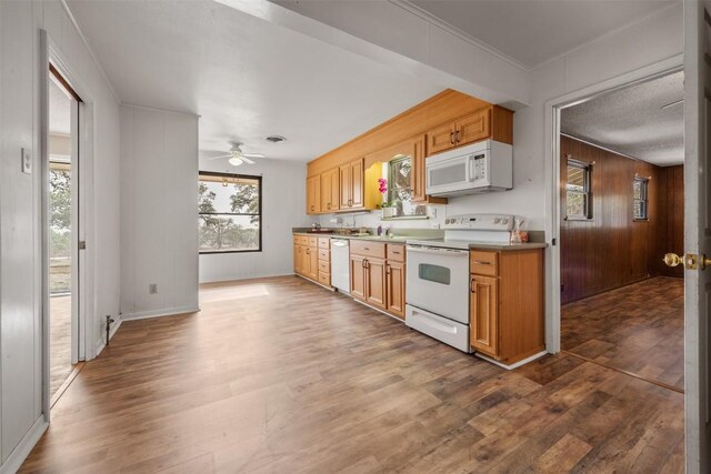 1876 Rocky Rd, Blanco, TX 78606 - kitchen featuring white appliances, dark wood finished floors, ceiling fan, and wooden walls