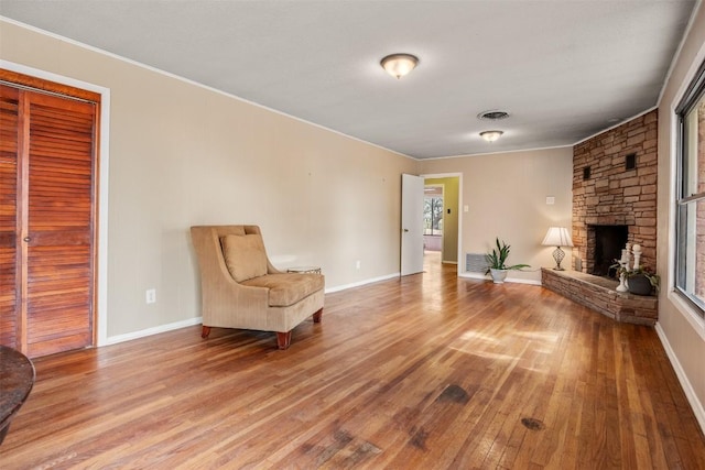 1876 Rocky Rd, Blanco, TX 78606 - living area featuring wood finished floors, a fireplace, and ornamental molding