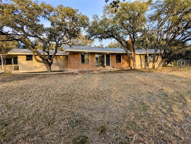 ranch-style home featuring metal roof