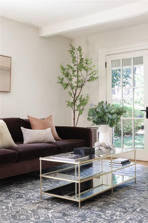 living room with a wealth of natural light and beamed ceiling