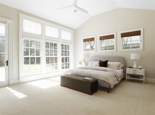 bedroom with vaulted ceiling, light carpet, and a ceiling fan