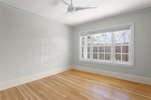 empty room featuring light wood-style flooring, baseboards, and ceiling fan