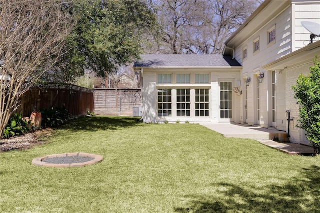 back of property featuring a yard, brick siding, and fence