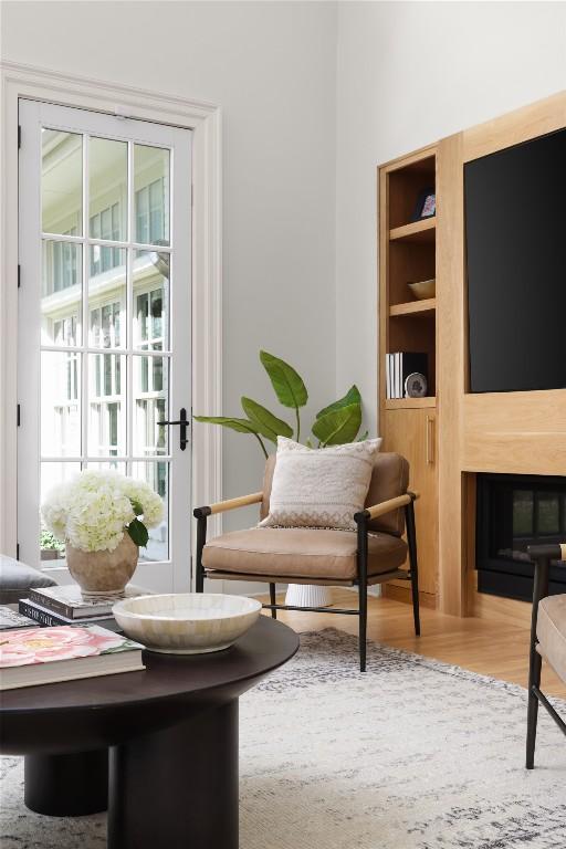 living area with built in features and wood finished floors