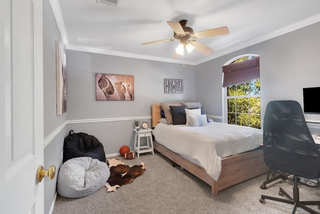 bedroom with crown molding, visible vents, carpet flooring, ceiling fan, and baseboards