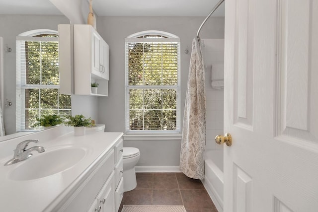 bathroom featuring a wealth of natural light, tile patterned flooring, vanity, and toilet